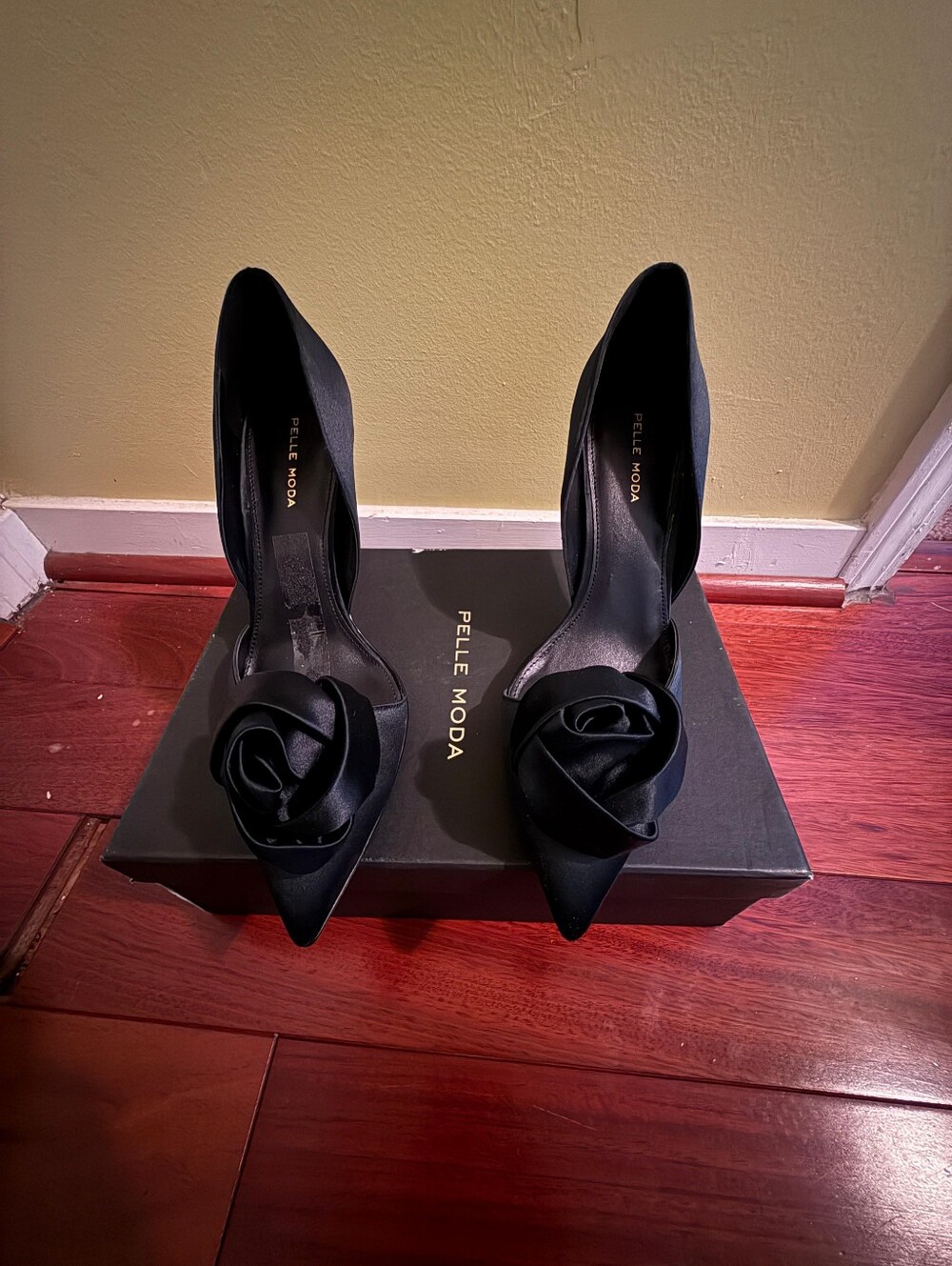 Pelle Moda Black Satin Pointed Toe Pumps with Floral Accent